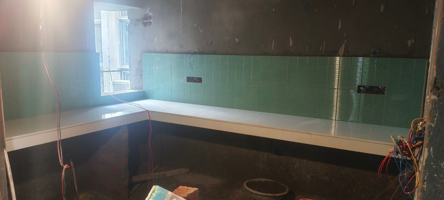 green kitchen wall tiles installed near countertop